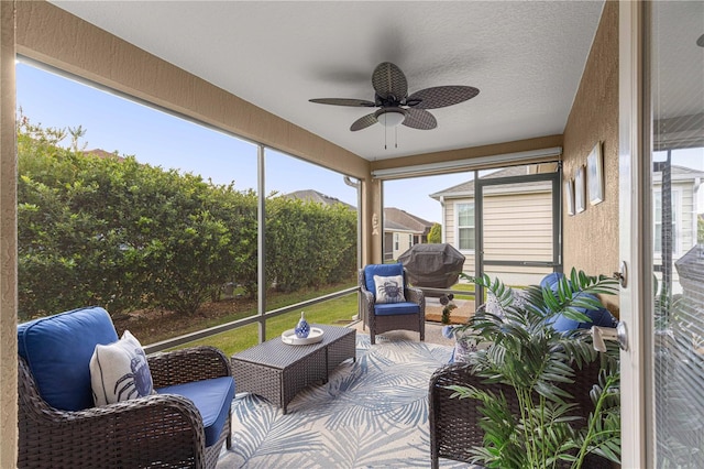 sunroom / solarium featuring ceiling fan