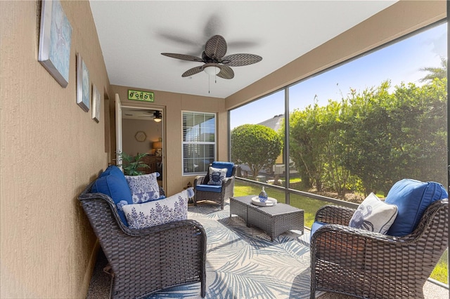 sunroom / solarium featuring ceiling fan