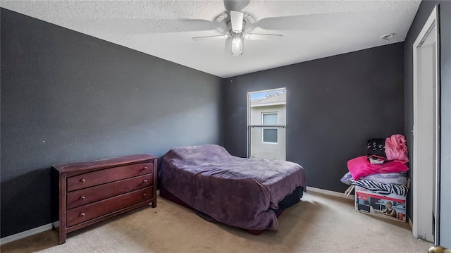 carpeted bedroom with a textured ceiling and ceiling fan