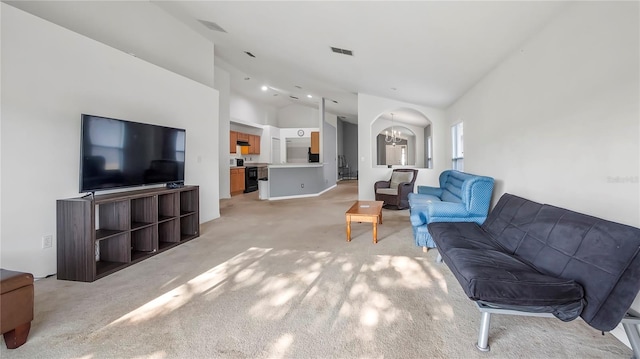 living room with light colored carpet and vaulted ceiling