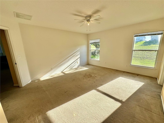 carpeted empty room with ceiling fan