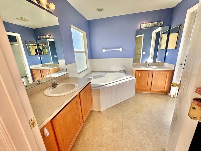 bathroom with tile patterned flooring, vanity, and plus walk in shower