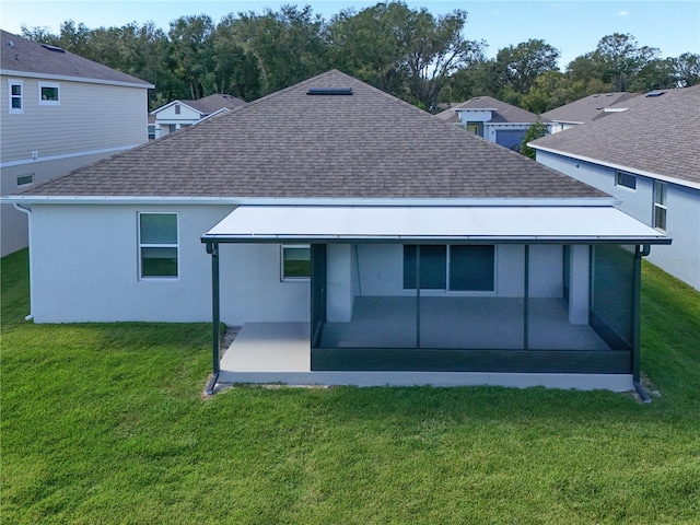 rear view of house with a yard