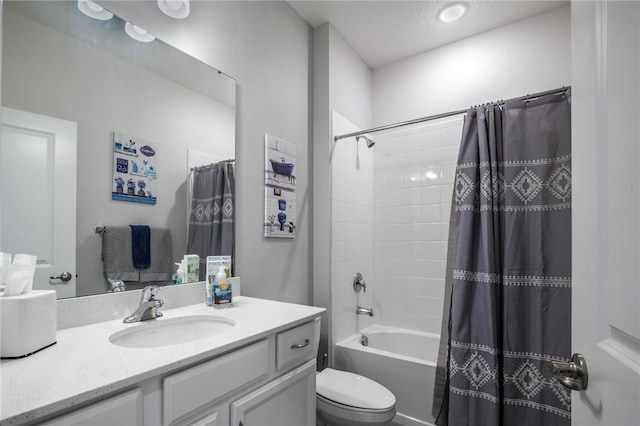 full bathroom featuring vanity, toilet, shower / bath combination with curtain, and a textured ceiling