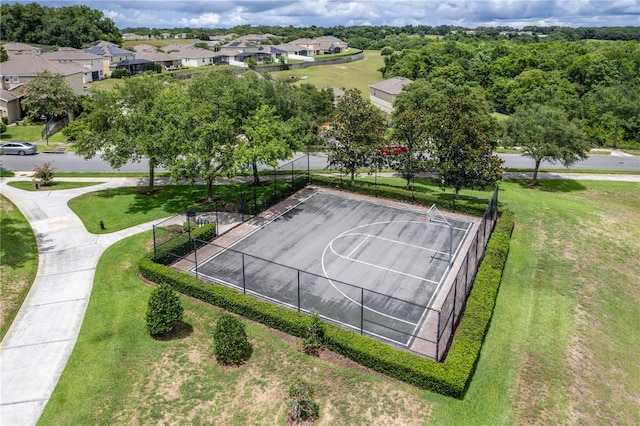 view of sport court featuring a yard