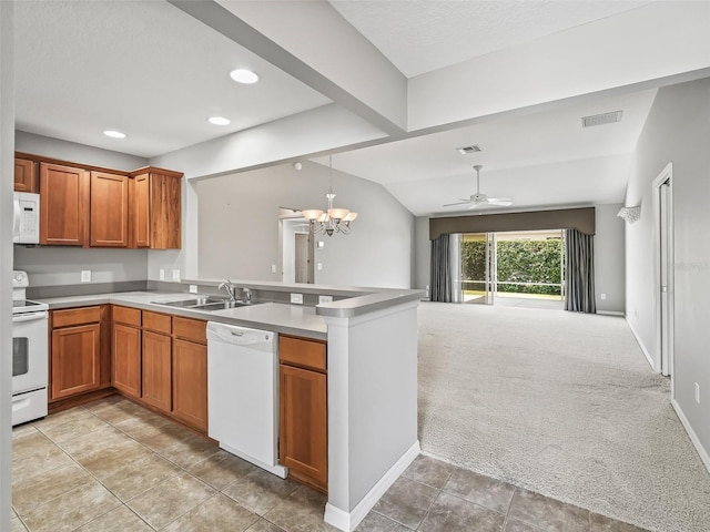 kitchen featuring white appliances, sink, kitchen peninsula, lofted ceiling, and light colored carpet