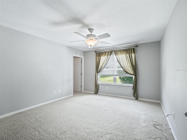 carpeted empty room with a textured ceiling and ceiling fan