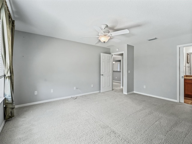 empty room with ceiling fan and carpet