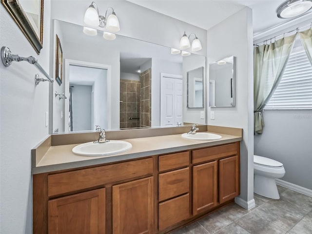 bathroom with vanity, a chandelier, toilet, and tile patterned flooring