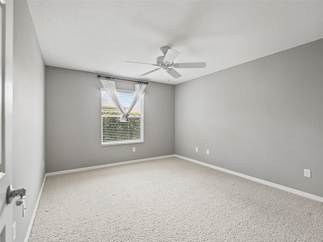 unfurnished room with ceiling fan, carpet, and a textured ceiling