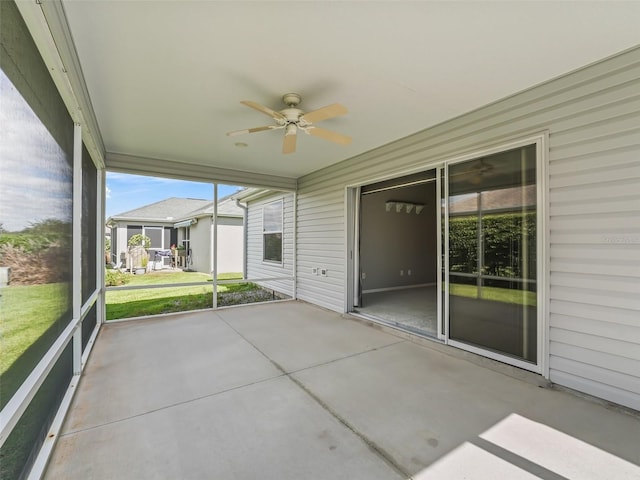 unfurnished sunroom featuring a wealth of natural light and ceiling fan