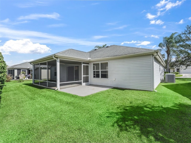 rear view of house with a yard, central air condition unit, a patio area, and a sunroom