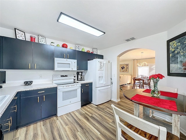 kitchen featuring light hardwood / wood-style flooring, blue cabinets, and white appliances