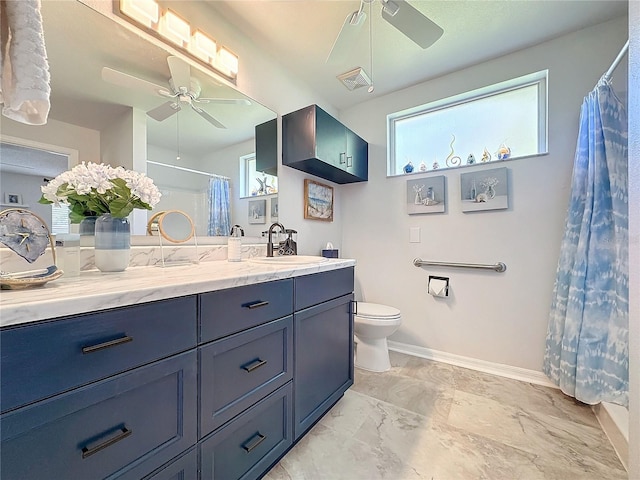 bathroom with vanity, toilet, and ceiling fan