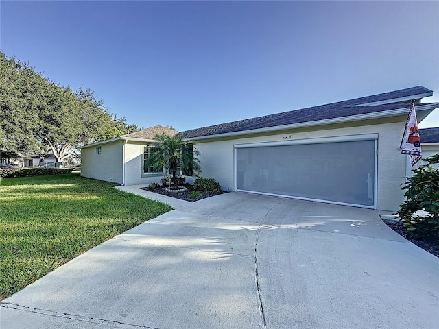 single story home with a front yard and a garage