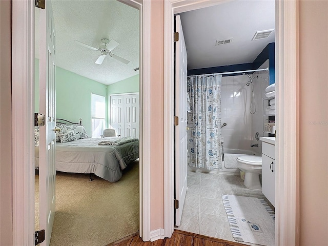 bathroom featuring toilet, shower / bath combination with curtain, wood-type flooring, a textured ceiling, and ceiling fan