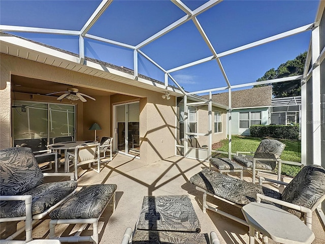 view of patio / terrace with glass enclosure and ceiling fan