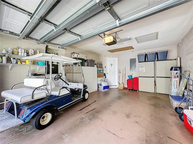 garage featuring a garage door opener and electric panel