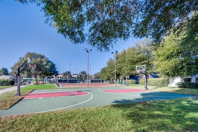 view of basketball court featuring a lawn