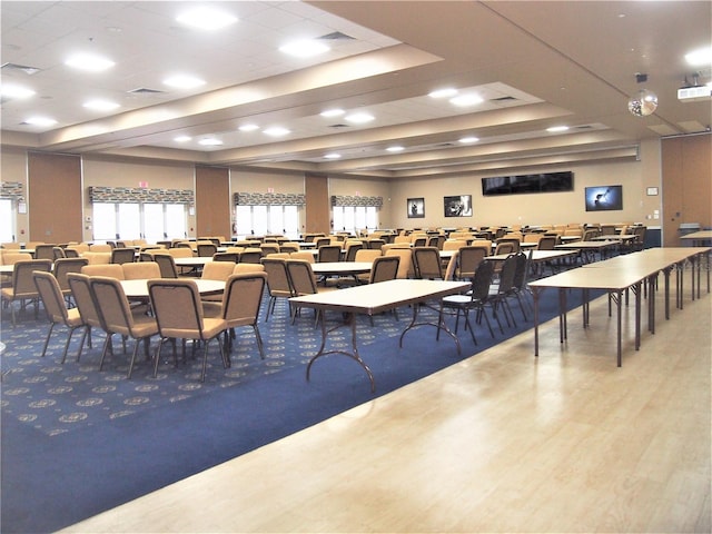 dining area featuring hardwood / wood-style flooring and a tray ceiling