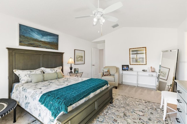 bedroom with ceiling fan, lofted ceiling, and light colored carpet