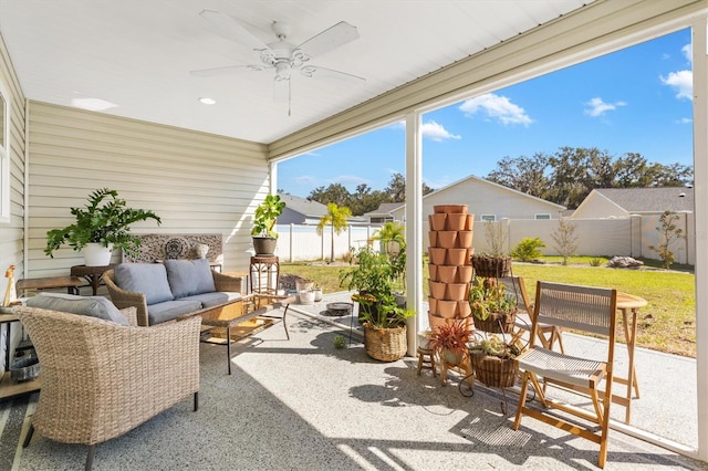 sunroom / solarium featuring ceiling fan