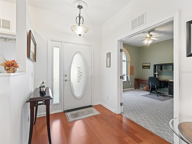 entrance foyer with built in desk, wood-type flooring, plenty of natural light, and ceiling fan