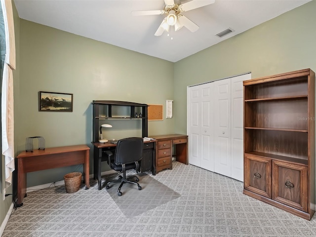 carpeted home office with ceiling fan