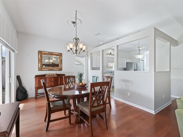 dining space featuring an inviting chandelier and wood-type flooring