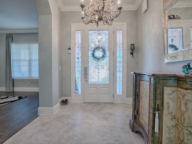 foyer featuring crown molding, light tile patterned flooring, and a chandelier