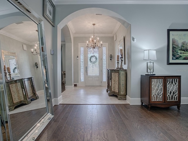 foyer with crown molding and dark hardwood / wood-style flooring