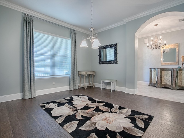 unfurnished dining area with ornamental molding, dark wood-type flooring, and an inviting chandelier