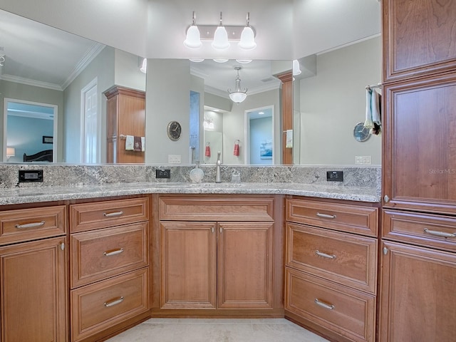 bathroom with vanity and ornamental molding