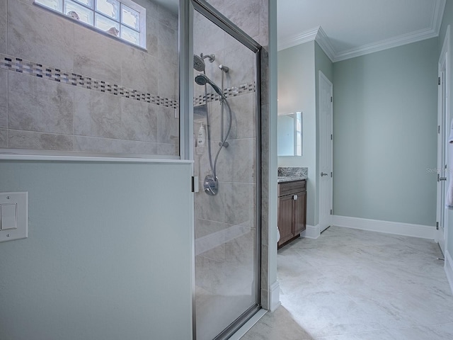 bathroom with vanity, crown molding, and a shower with door