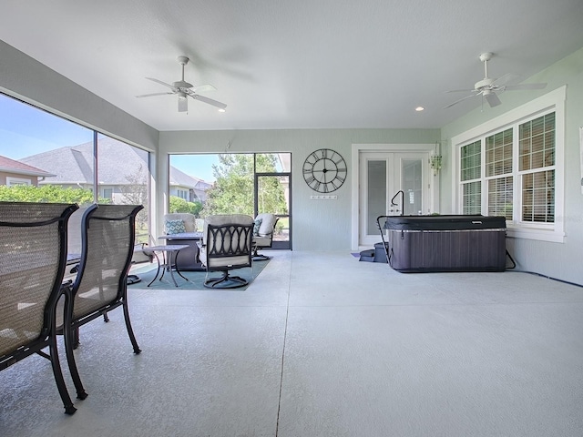 sunroom with ceiling fan and a jacuzzi