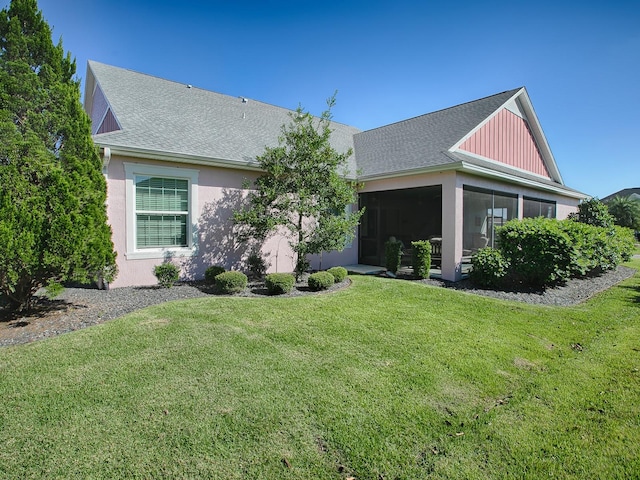 view of front of property featuring a sunroom and a front yard