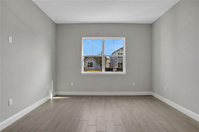 empty room with light hardwood / wood-style flooring