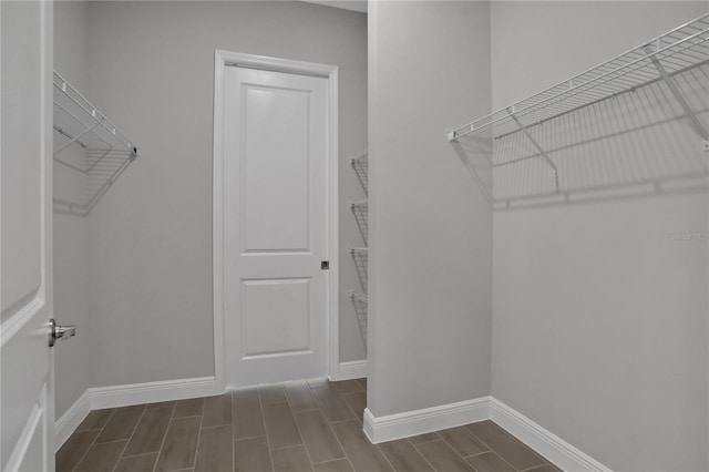 walk in closet featuring dark wood-type flooring