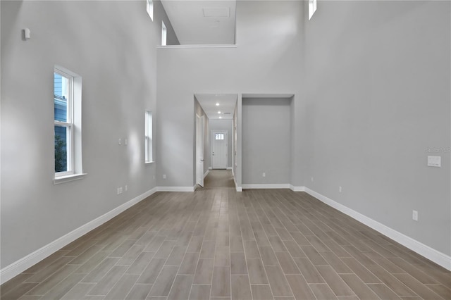 interior space featuring hardwood / wood-style flooring and a high ceiling