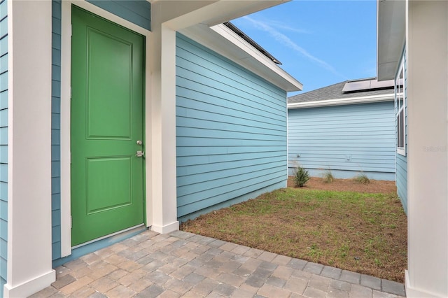 property entrance with a lawn