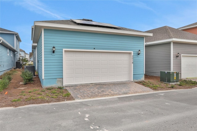 garage featuring solar panels and central AC