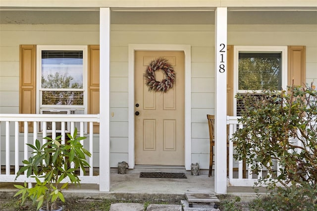 view of exterior entry featuring a porch