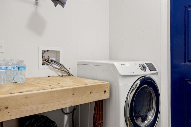 clothes washing area with washer / dryer