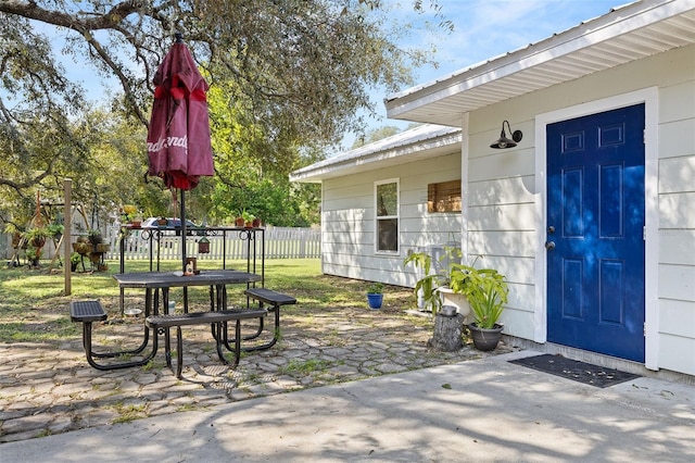 view of exterior entry featuring a patio area