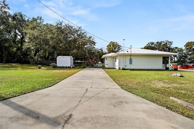 view of side of property featuring a storage shed and a yard