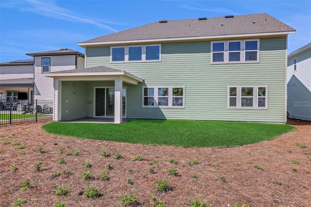 back of property with a patio area, a yard, and fence