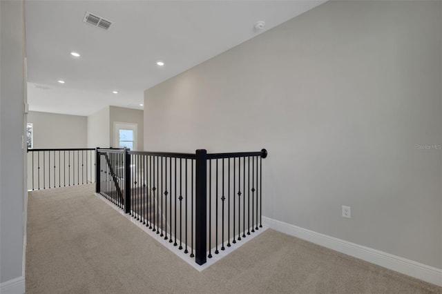 hall featuring carpet flooring