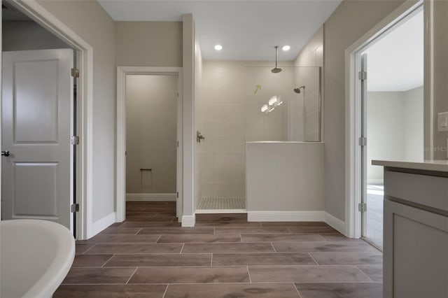 bathroom featuring shower with separate bathtub and vanity