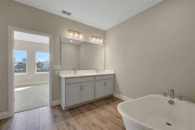 bathroom with vanity and a tub