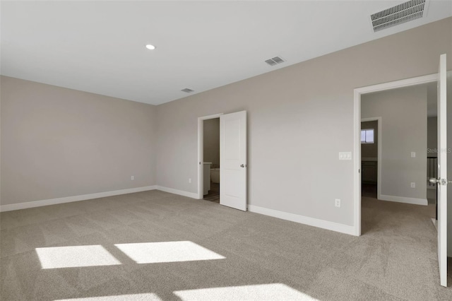 unfurnished bedroom featuring light carpet